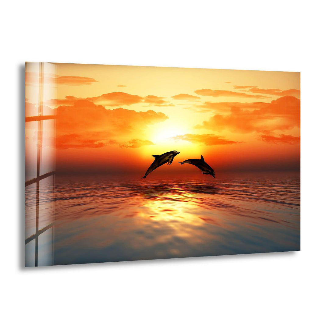 Stunning sunset with playful dolphins leaping over calm ocean waters.
