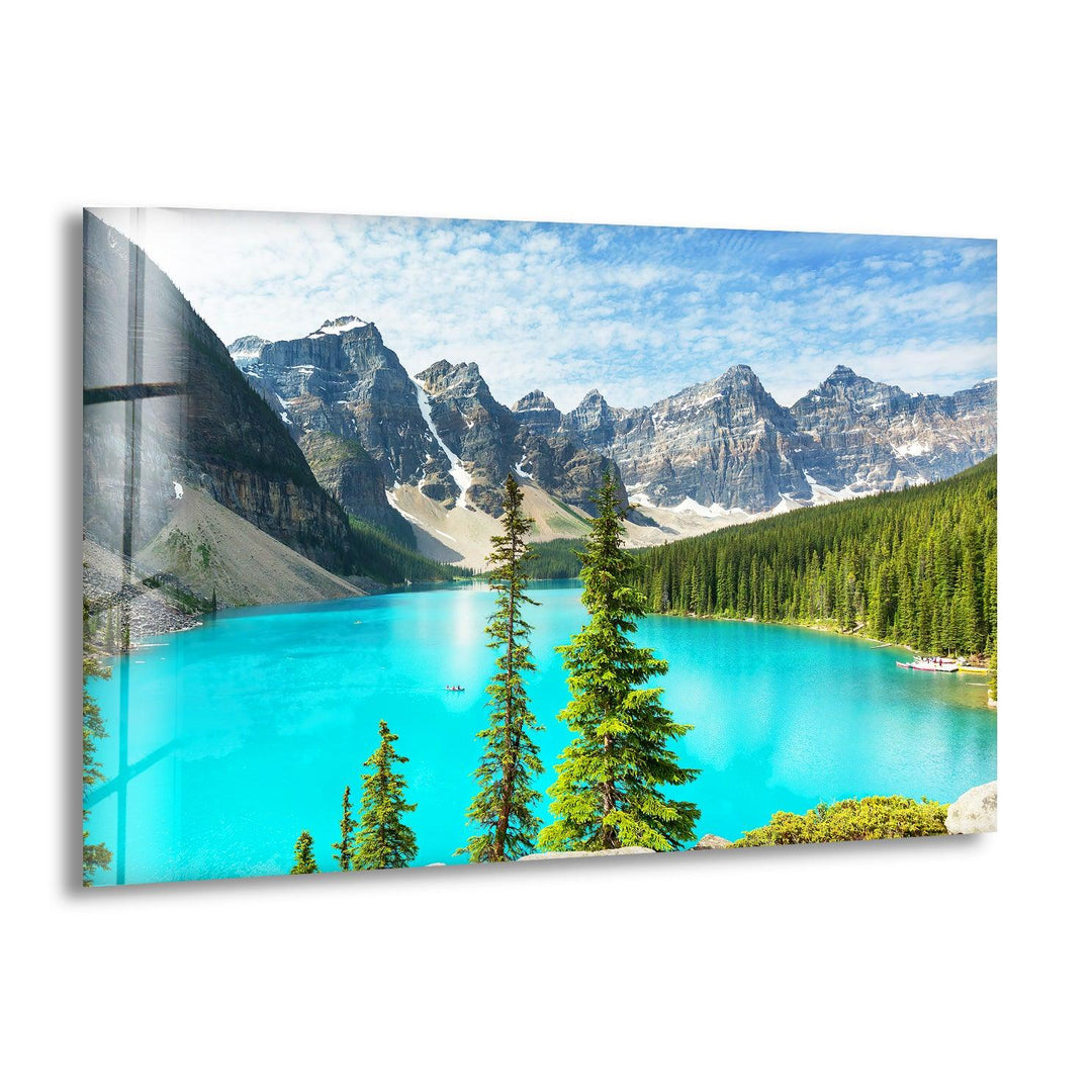 A serene glass wall art capturing the stunning Moraine Lake with turquoise waters and towering mountains.
