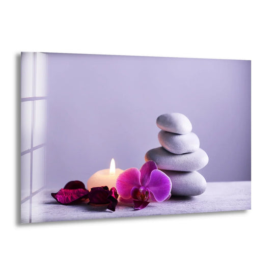 A purple orchid, dried petals, and a lit candle rest on a textured surface, featured in this glass printing.