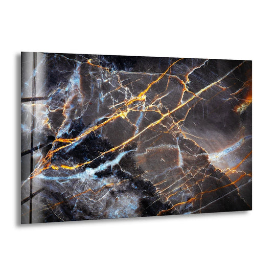 A dark gray marble with gold ink glass wall art prints features highly saturated, vibrant gold and electric blue veins against a deep charcoal background.