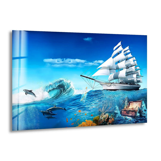 A majestic sailboat glides across a churning wave, while dolphins leap and swim through the dynamic art from glass.