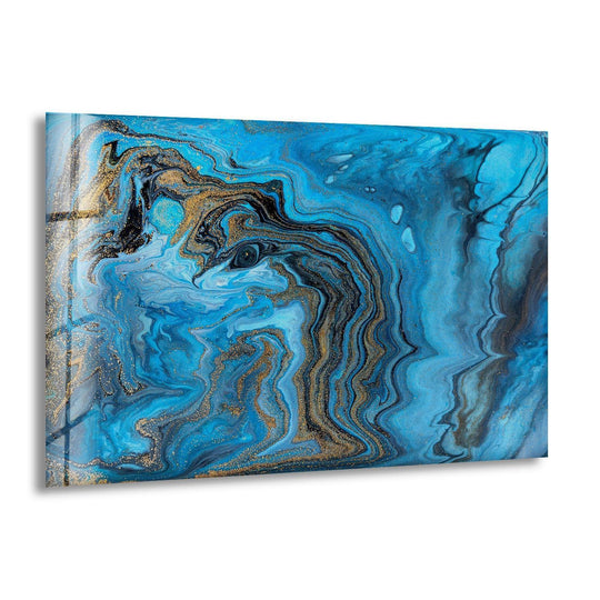 This abstract glass wall art showcases a glossy finish with swirling navy, azure, and black hues accented by glittering gold home decor.