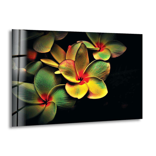 Vivid yellow and green plumeria flowers dominate this vibrant home decor glass wall art.