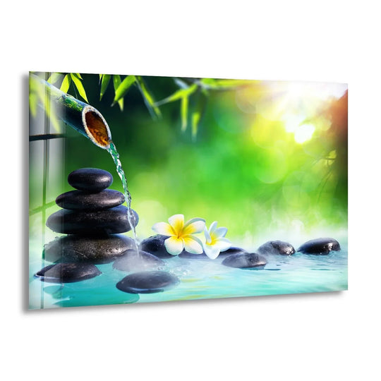 Stacked geometric stones and a bamboo spout create a tranquil water feature in this glass wall artwork.