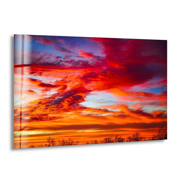 A breathtaking sunset sky with fiery red and orange clouds above a serene landscape.
