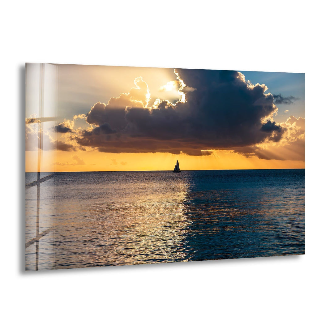 Tranquil ocean sunset with a lone sailboat, creating a peaceful and serene atmosphere.

