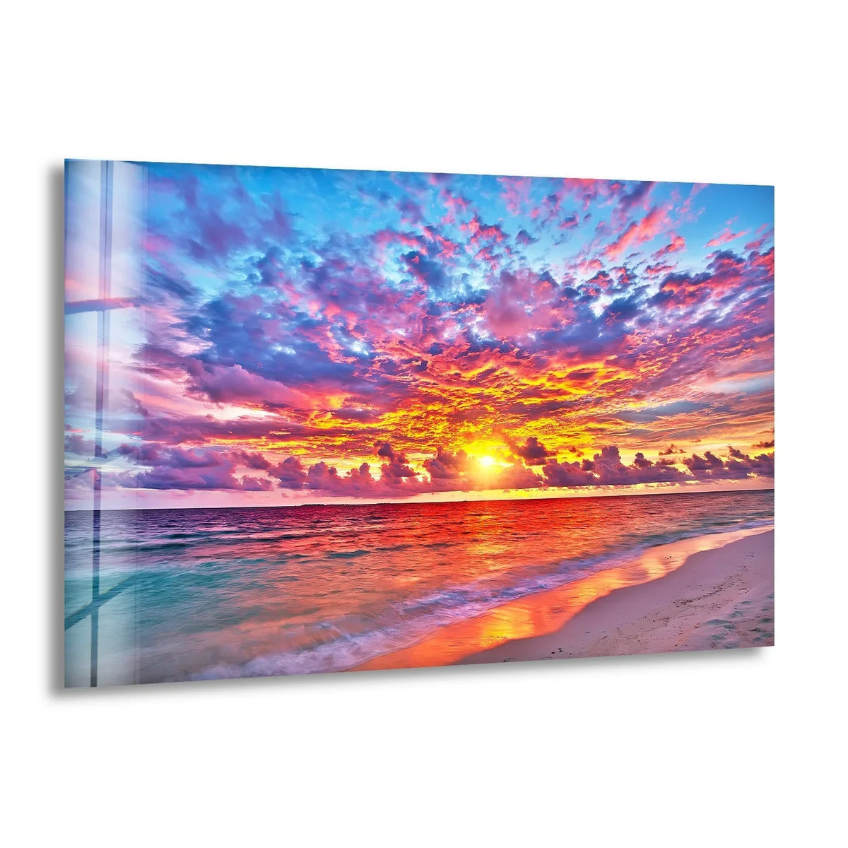Light and shadow dance across the serene ocean in this colorful sunset glass wall art decor, highlighting the reflective wet sand and the vibrant sky above.
