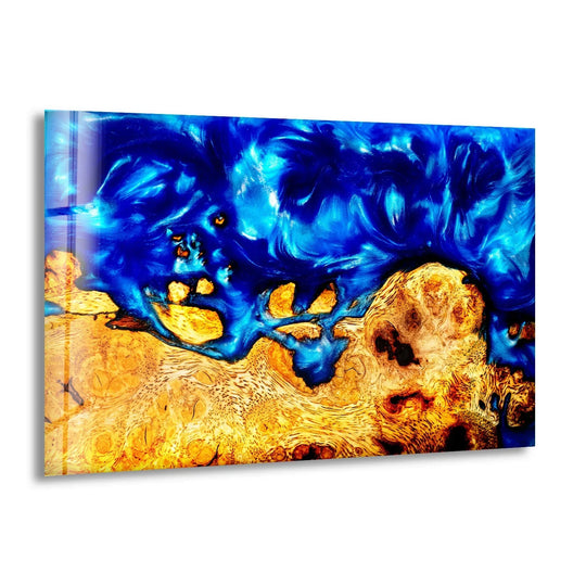 Vibrant sapphire blue resin swirls transition into golden wood grain in this abstract epoxy resin and wood glass wall art.