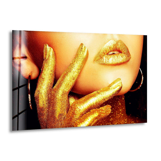 A glamorous golden hand and lips on a dark background create high color contrast on this tempered glass wall art.