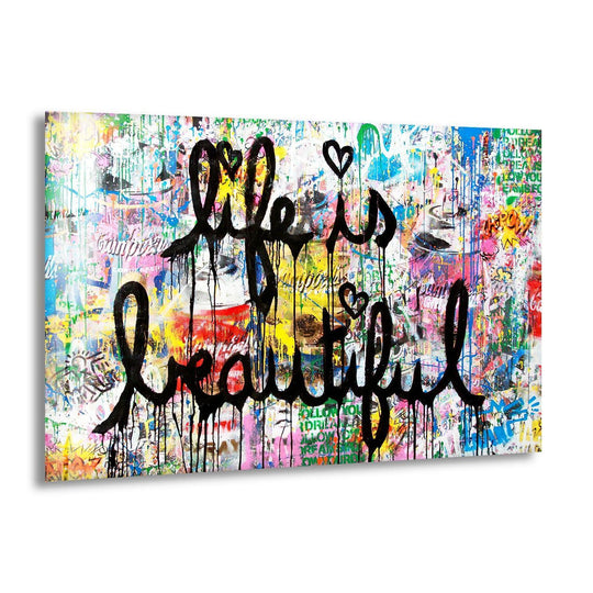 Life is Beautiful Banksy glass wall art with colorful graffiti and dripping black script is a bold piece of modern wall decor