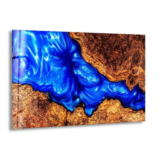 Bright light glints off swirling sapphire epoxy within this striking abstract wall print, casting deep shadows across textured wood grain.