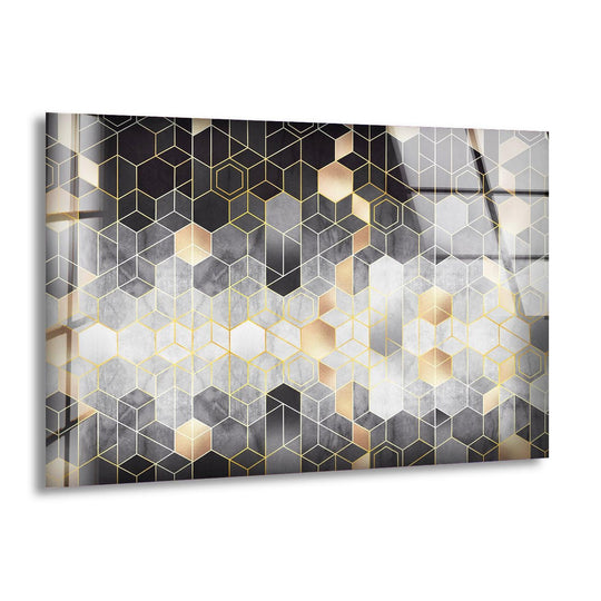 Abstract glass art featuring a cool geometric pattern of black, grey, and gold hexagons with ample negative space.