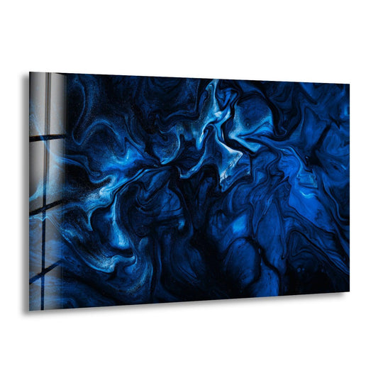 A contemporary glass wall art decor piece with a dark blue abstract design and a sleek, reflective edge.
