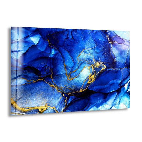 Deep sapphire and azure layers in this glass wall art print swirl with veins of shimmering gold.