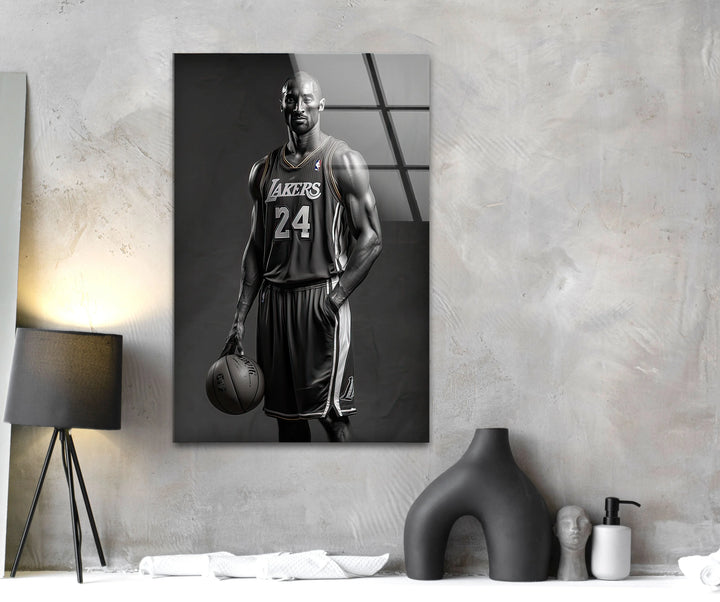 Grayscale portrait of a basketball player wearing a Lakers 24 jersey while gripping a basketball.