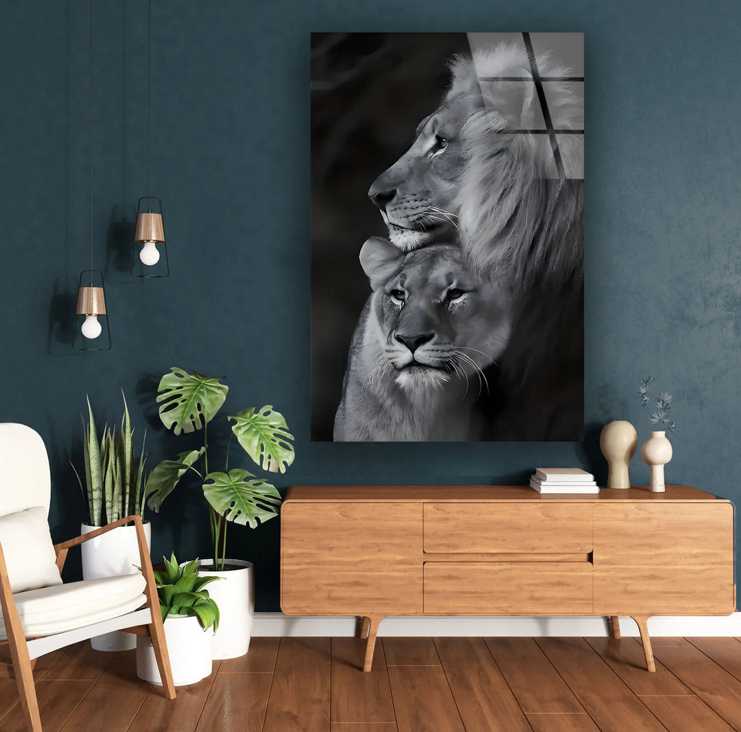 Monochrome lion couple captured in a calm and protective pose on glass wall art.