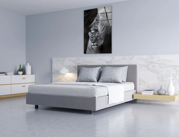 Grayscale glass print featuring a lion and lioness gazing into the distance with quiet strength.