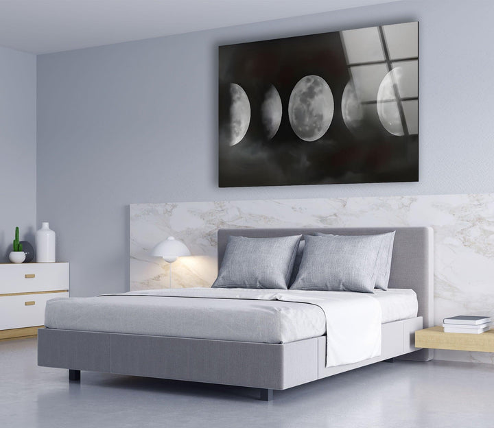 Black and white moon phase design on glass with fog-covered night atmosphere.