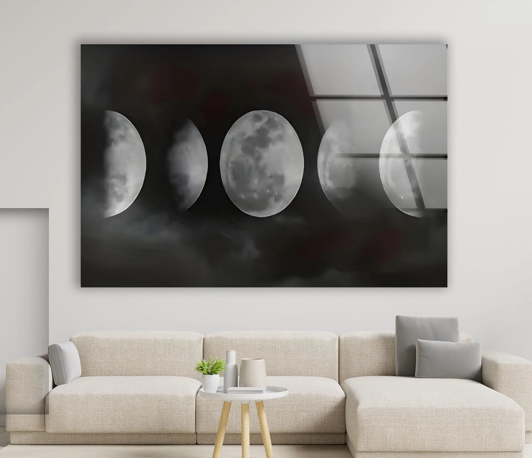 Monochrome lunar phase artwork on glass featuring glowing moons against a foggy night sky.