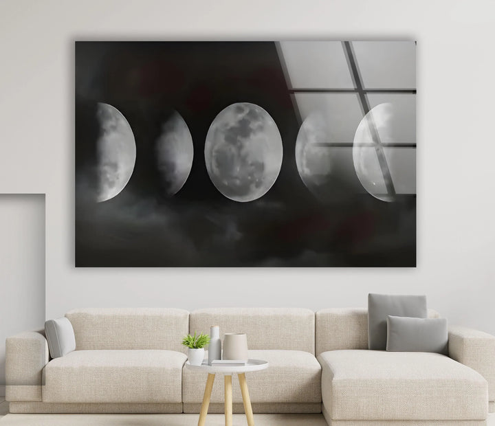 Monochrome lunar phase artwork on glass featuring glowing moons against a foggy night sky.