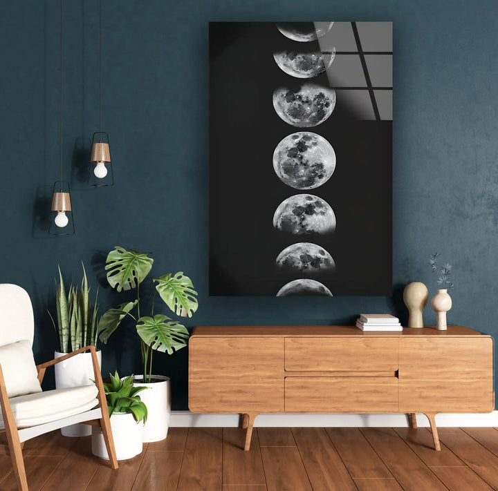 Celestial-themed glass wall art presenting realistic moon phases against a dark background.