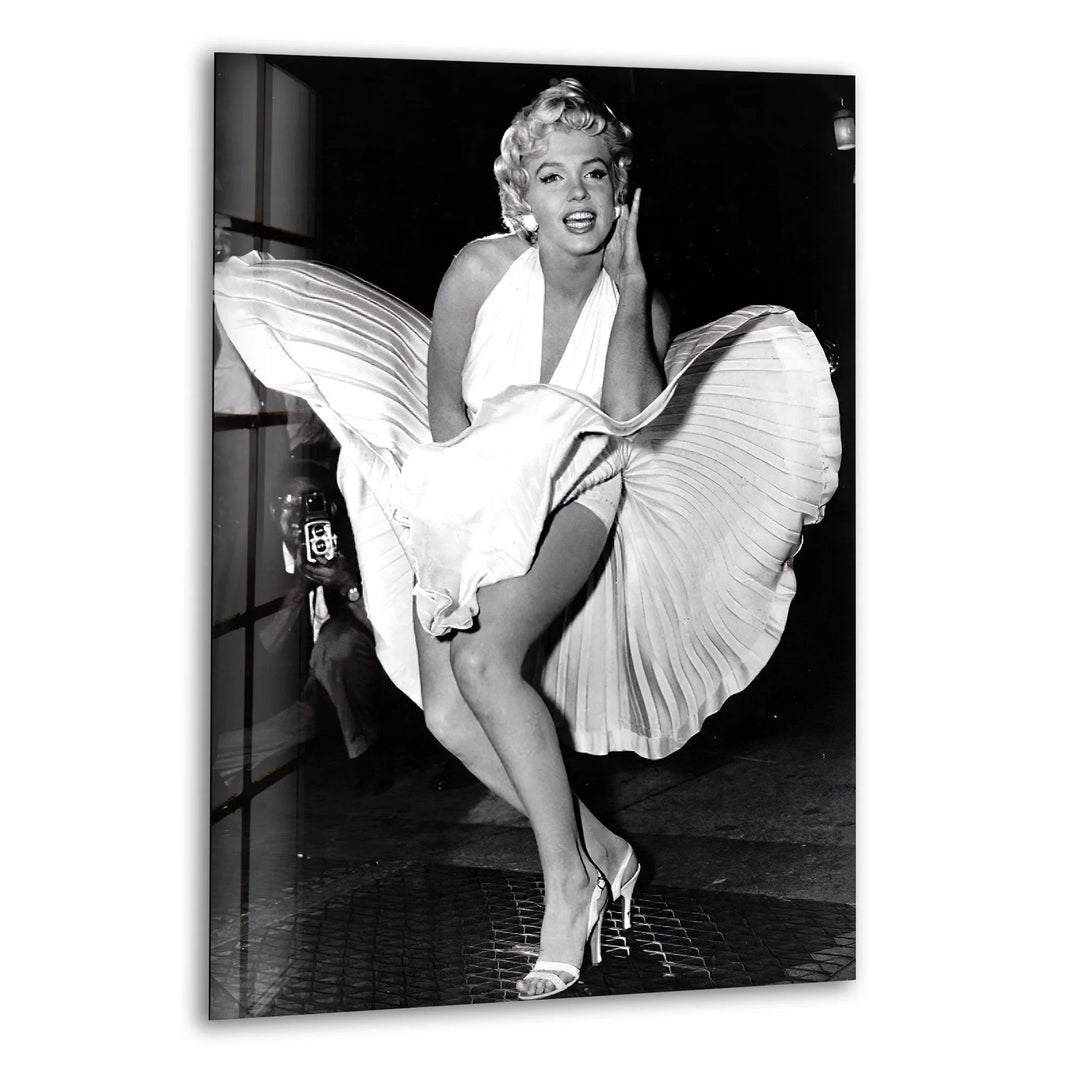 Marilyn Monroe standing over a subway grate with her white dress blowing upward.