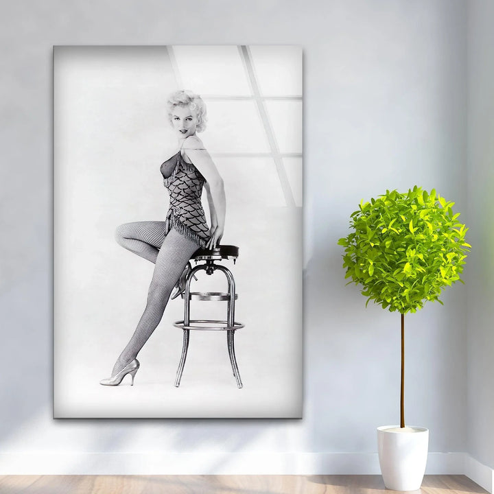 Timeless Marilyn Monroe pose captured in high-contrast black and white glass wall art.