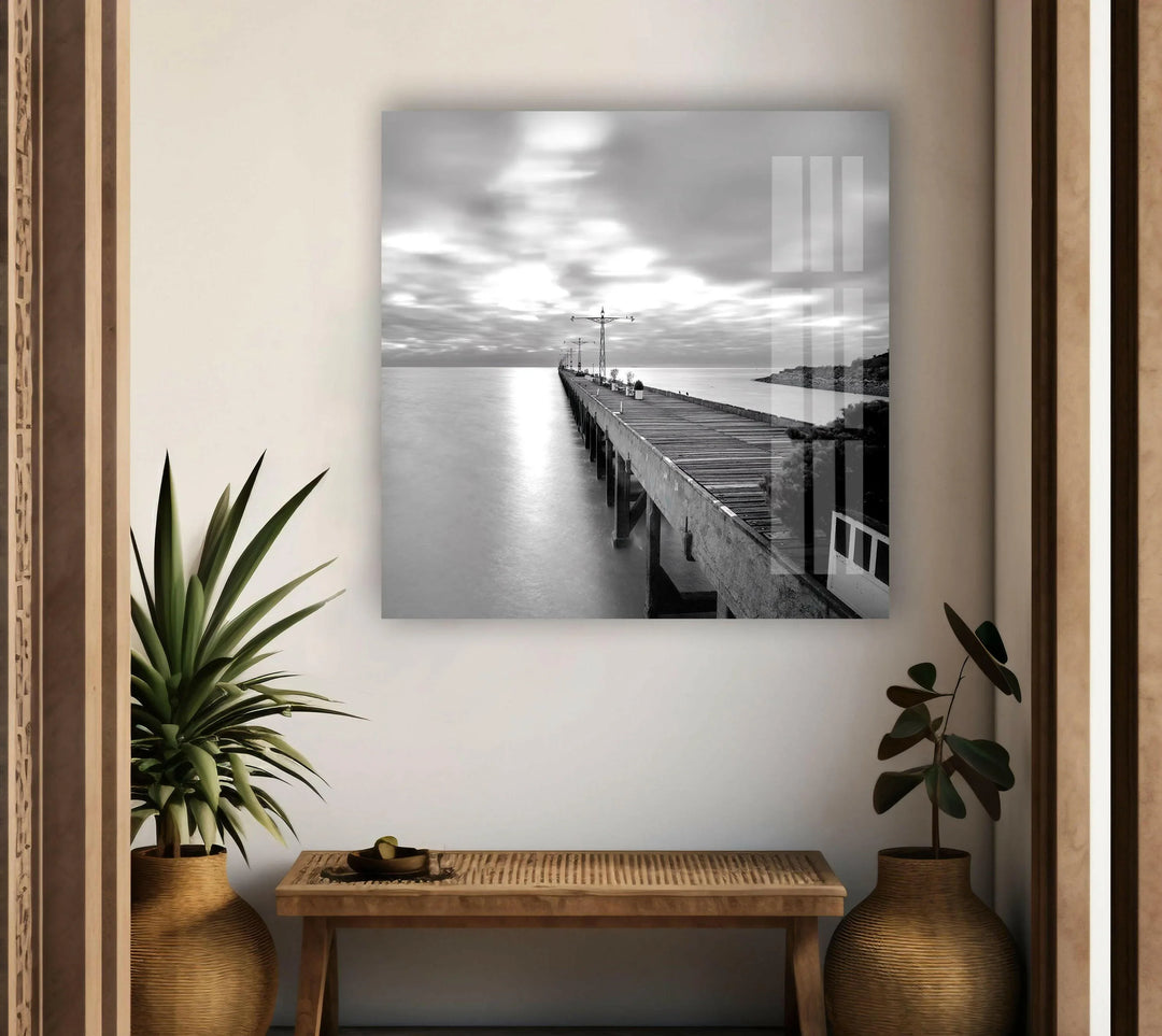 Calm seascape showcasing a long dock against a soft, glowing sky on tempered glass art.