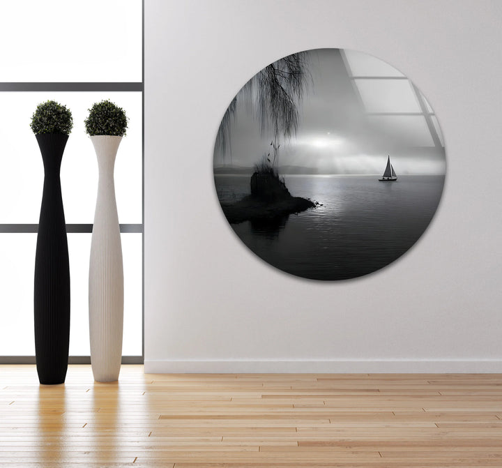 Silent lakeside scene with a sailboat under subtle glowing rays in monochrome glass art.