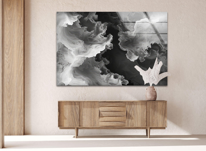 Modern glass wall art with drifting smoke shapes blending between bright whites and dark blacks.