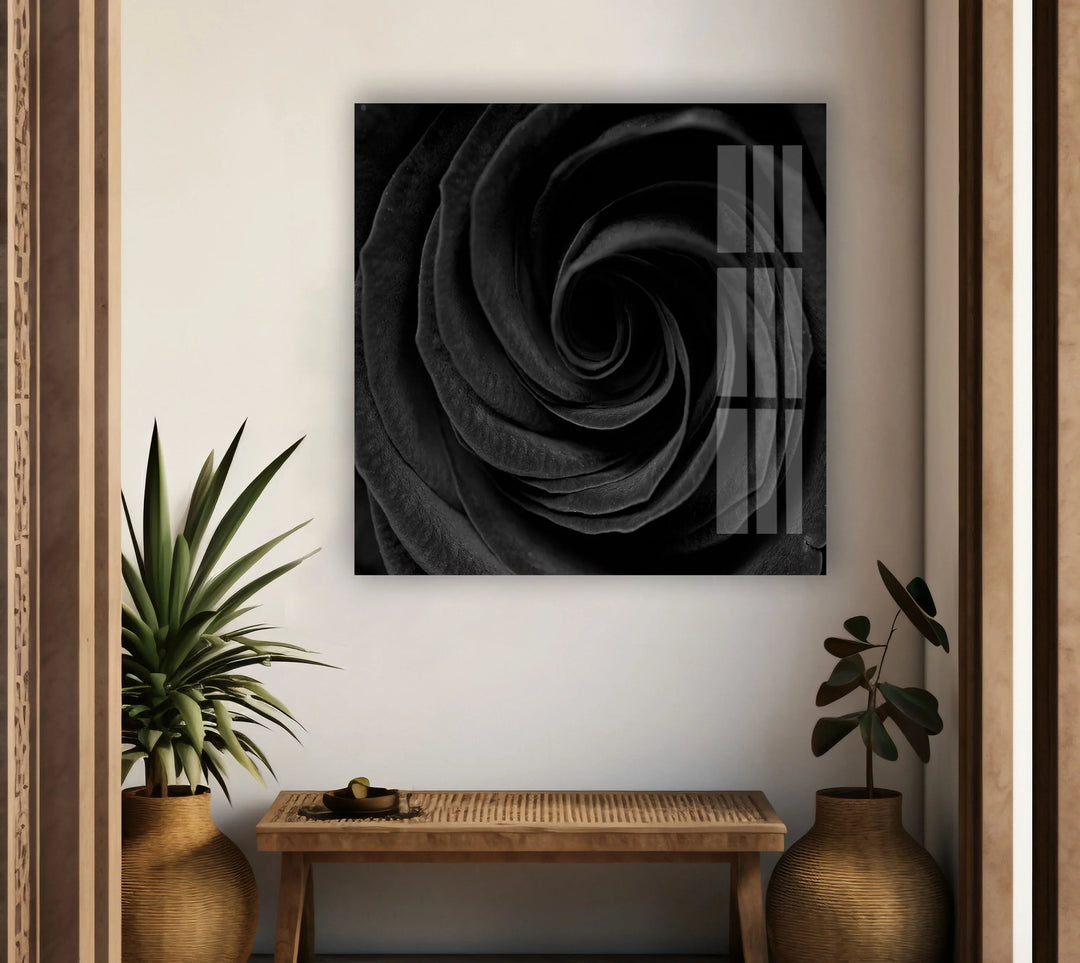 Dark floral swirl pattern showcasing a rose’s center in black and white on glass.