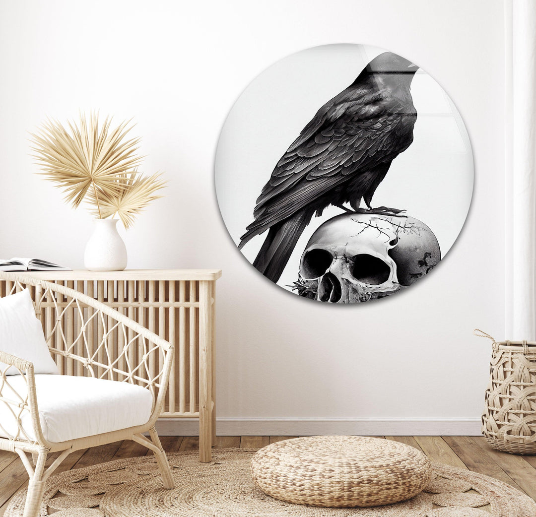 Dark-themed glass wall art with a lifelike raven perched on a cracked skull in dramatic grayscale tones.