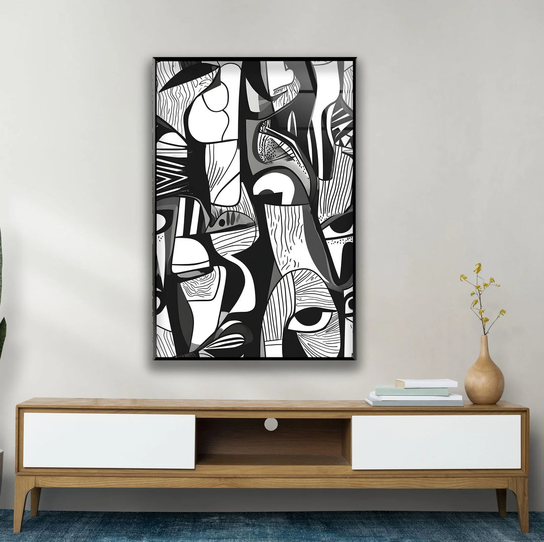 Black and white design on glass displaying layered geometric forms and abstract portrait fragments.
