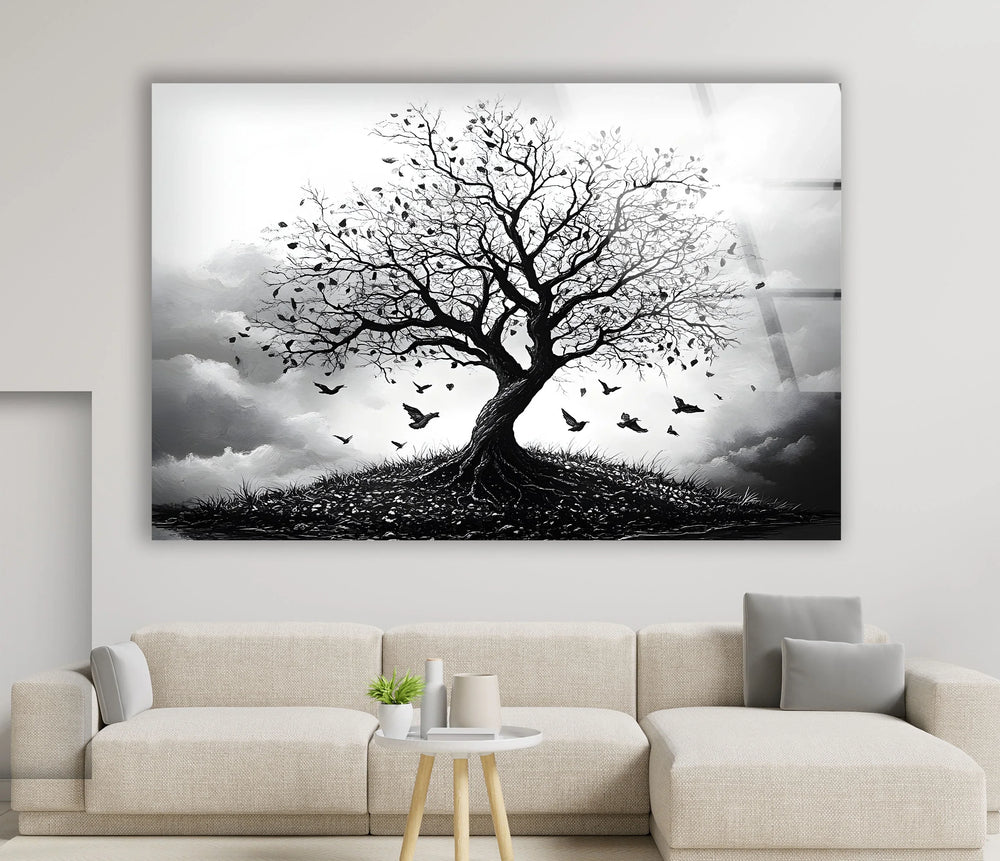 Monochrome tree artwork on tempered glass depicting a windswept tree with birds lifting into the air.
