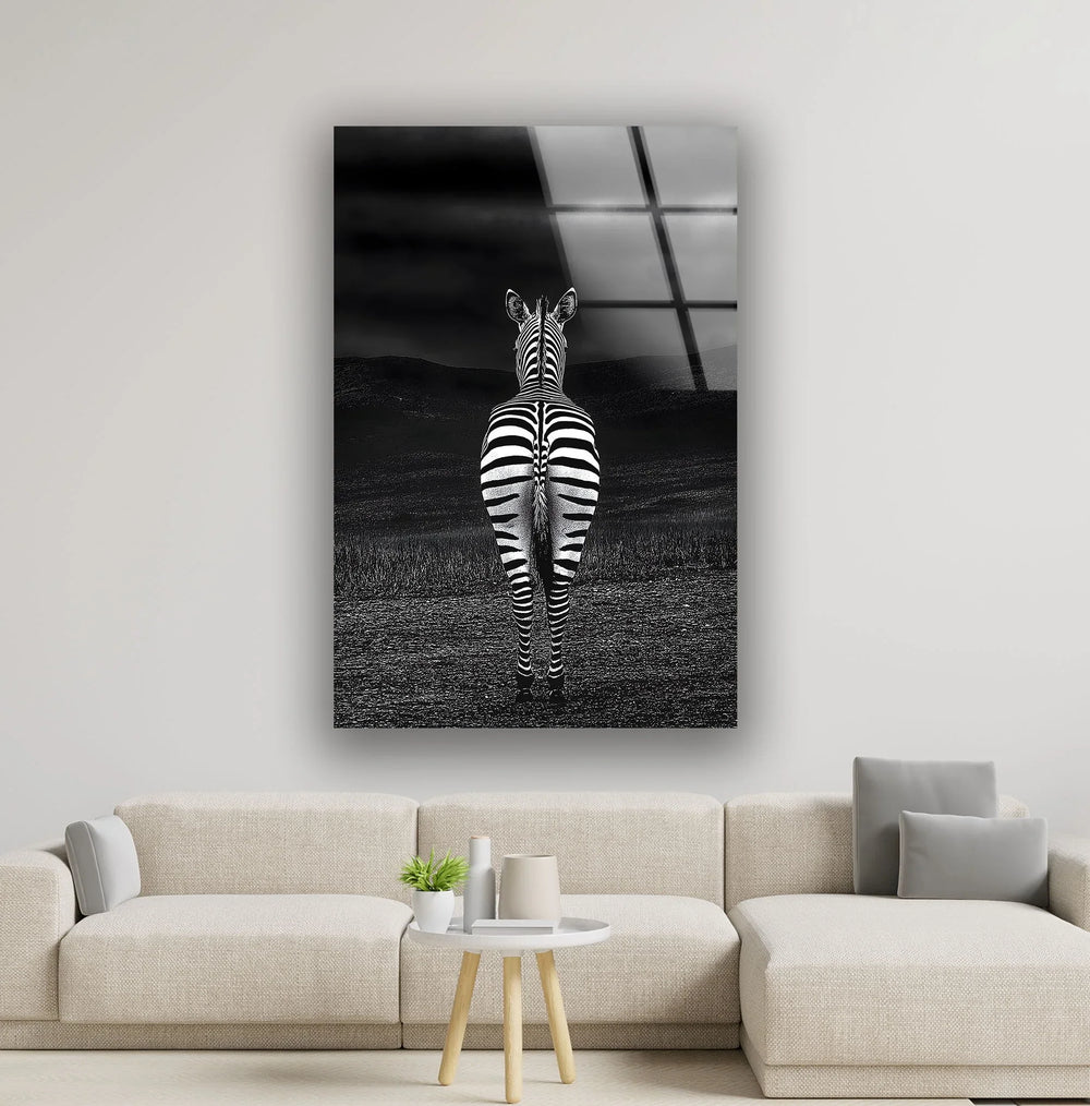 Monochrome zebra artwork on tempered glass showing a lone zebra facing the horizon in a dark landscape.