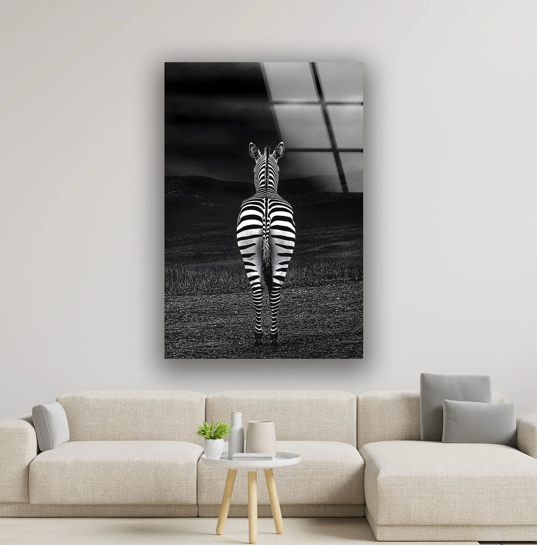 Monochrome zebra artwork on tempered glass showing a lone zebra facing the horizon in a dark landscape.
