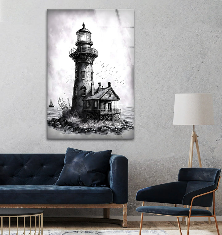 Black and white glass wall art of a vintage lighthouse and seaside cottage on a rocky shore.