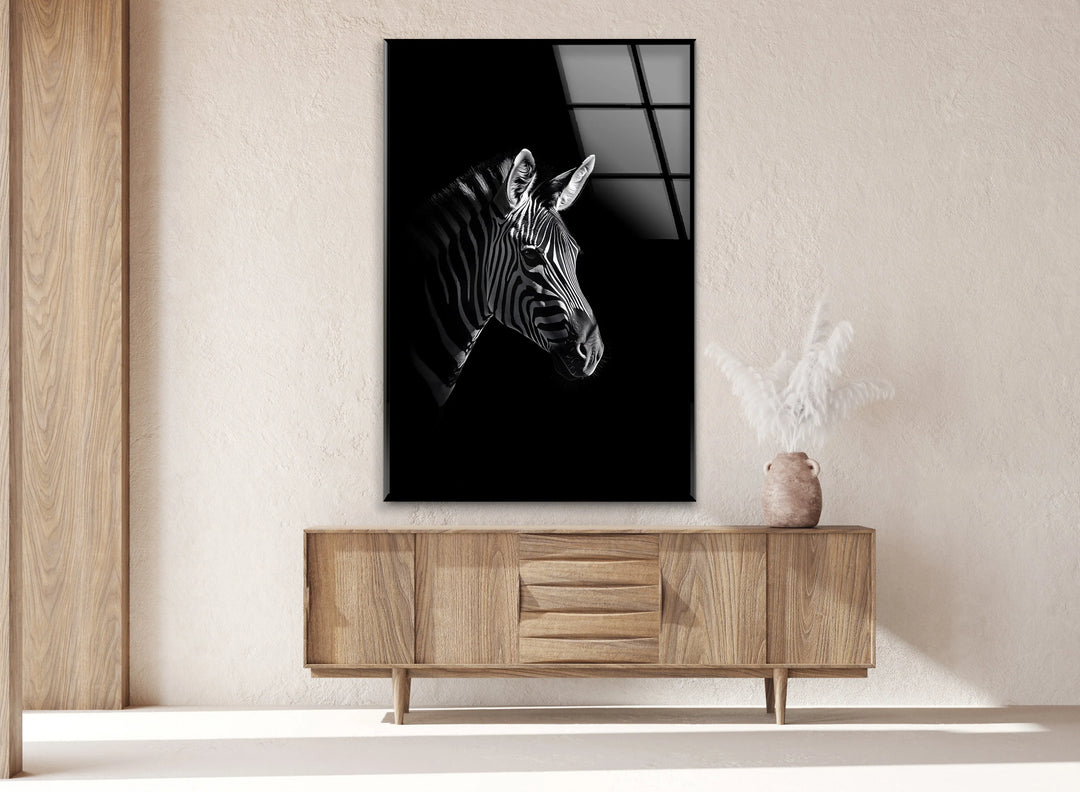 Black and white glass wall art of a zebra head emerging from a dark minimalist background.