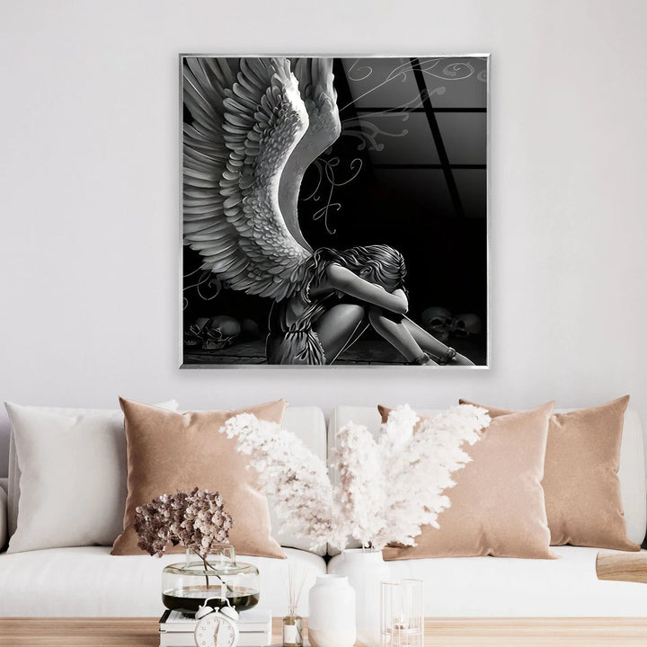 Expressive monochrome angel composition on glass showing folded wings and a reflective pose.