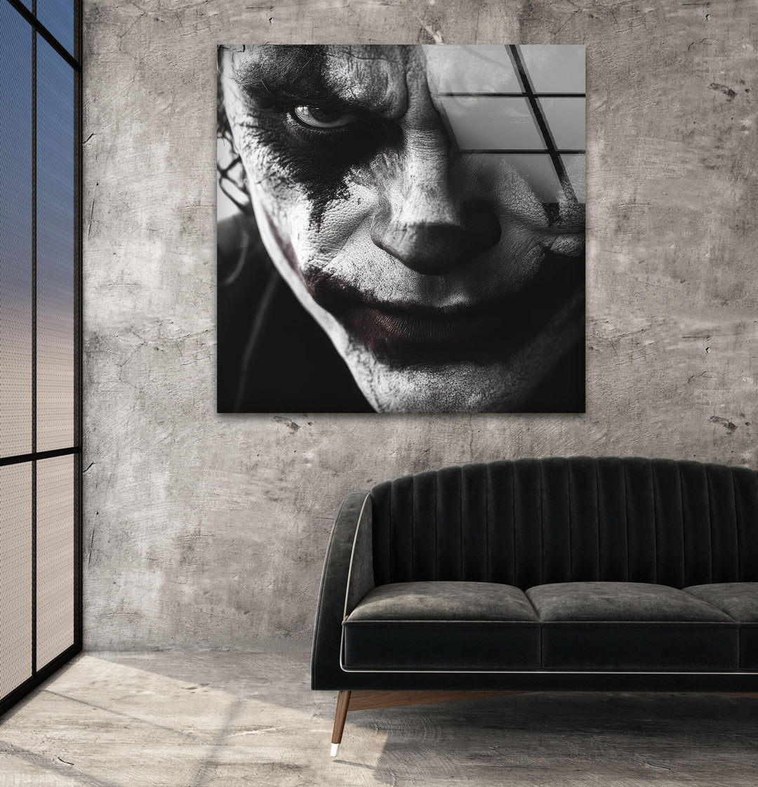 Black and white glass wall art featuring an intense close-up of a sinister clown face with dramatic makeup.