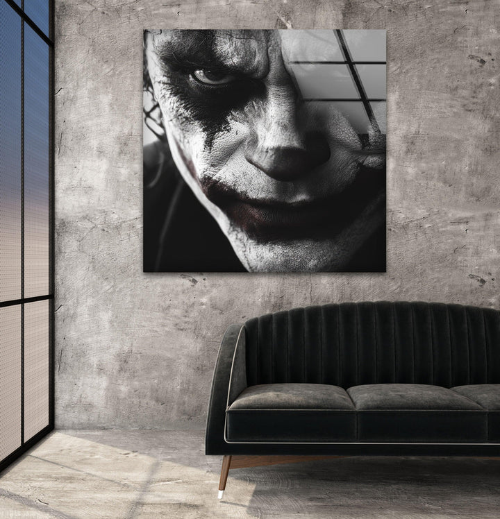 Black and white glass wall art featuring an intense close-up of a sinister clown face with dramatic makeup.