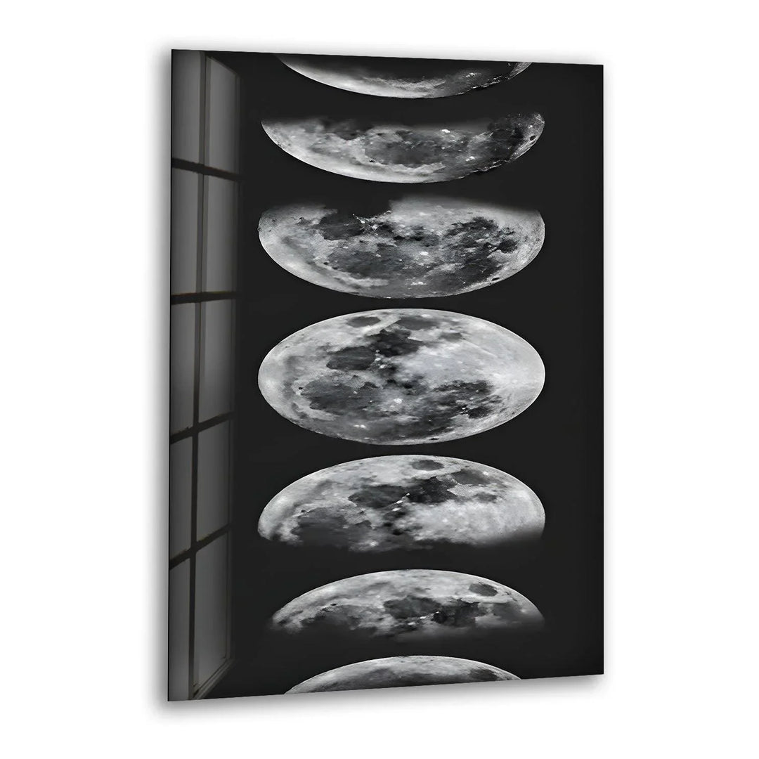 Black and white glass wall art displaying multiple moon phases in a vertical celestial design.