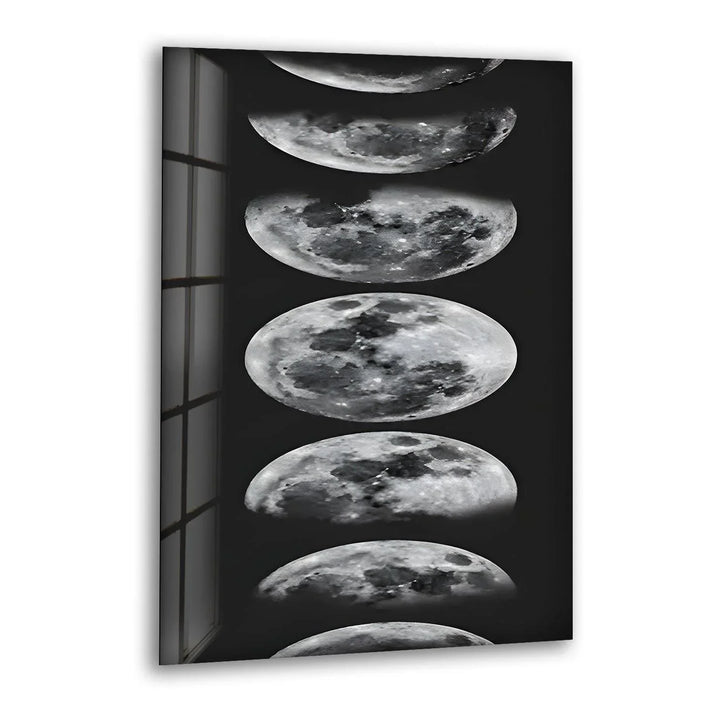 Black and white glass wall art displaying multiple moon phases in a vertical celestial design.