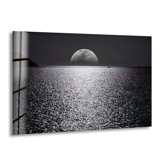 Landscape glass wall art shows a silvery ocean reflecting a full moon and is perfect for modern decor and a mesmerizing night scene