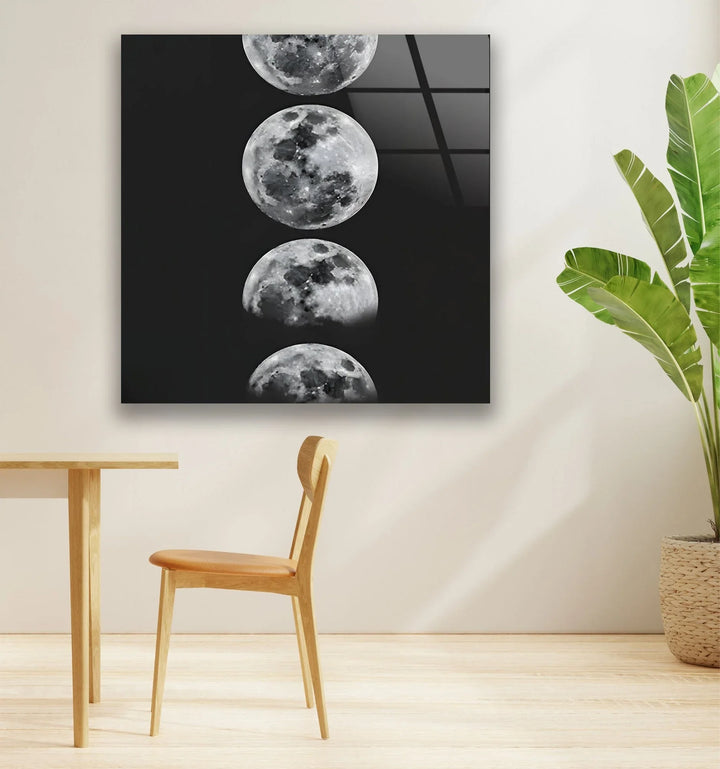 Black and white lunar cycle artwork on glass with a column of detailed moon images.