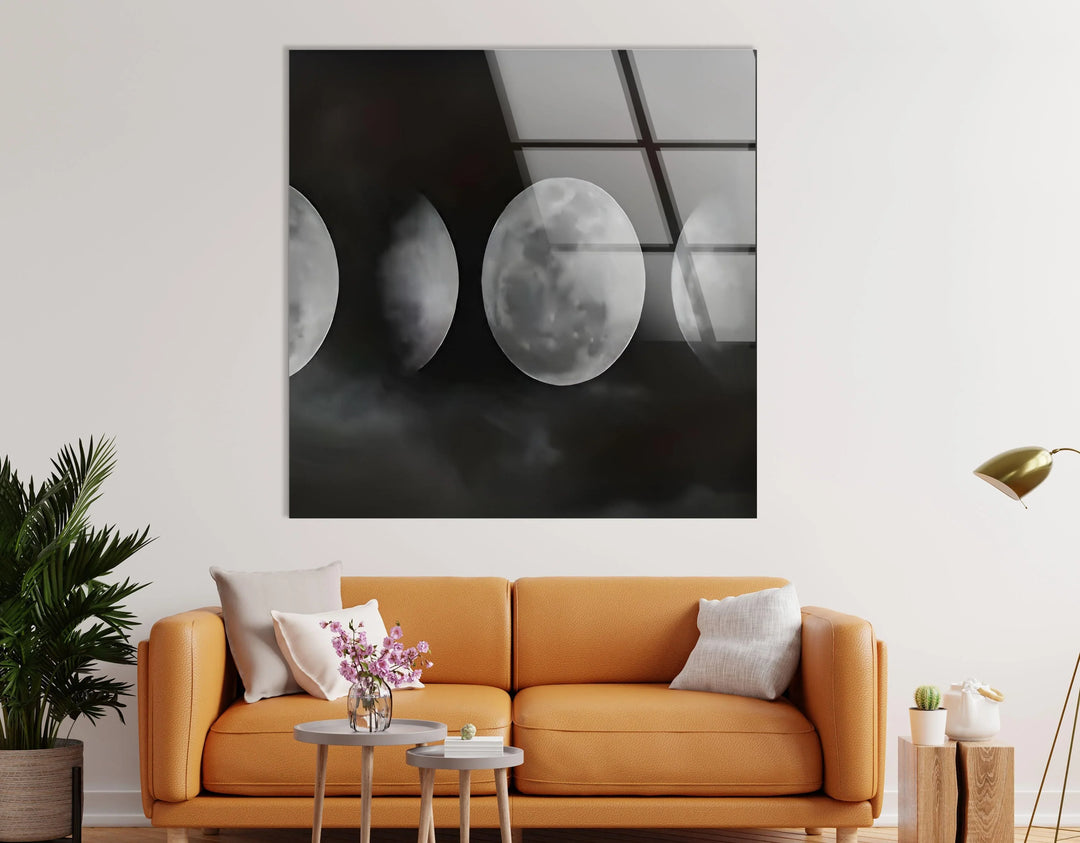 Grayscale lunar artwork featuring sequential moon phases floating above dark swirling clouds.