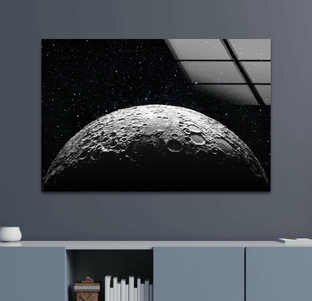 Photorealistic cratered moon emerging from darkness with stars scattered above on glass.