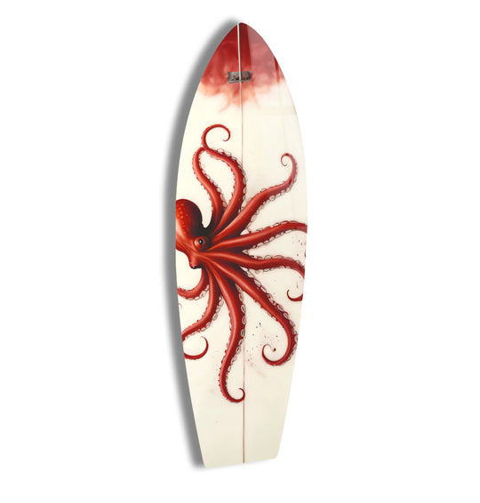 A vibrant red octopus adorns this surfboard as a striking piece of glass wall artwork.