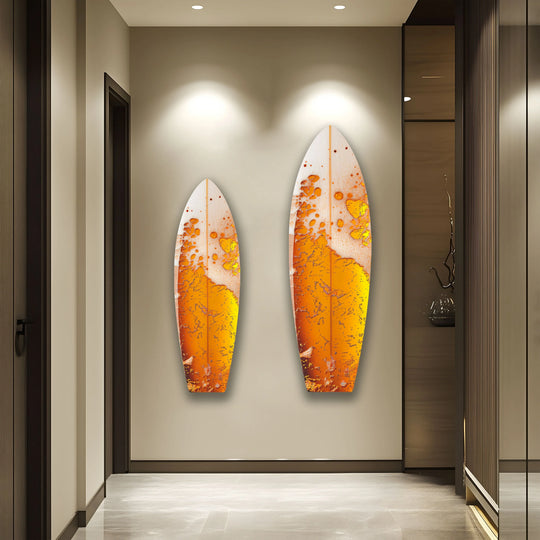 Two orange abstract surfboard glass wall art pieces create a captivating visual rhythm on a neutral wall.