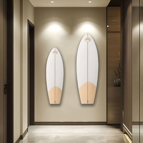 Highlighting the realistic detail, two brown and white surfboard home decor pieces adorn a neutral wall in a modern hallway.